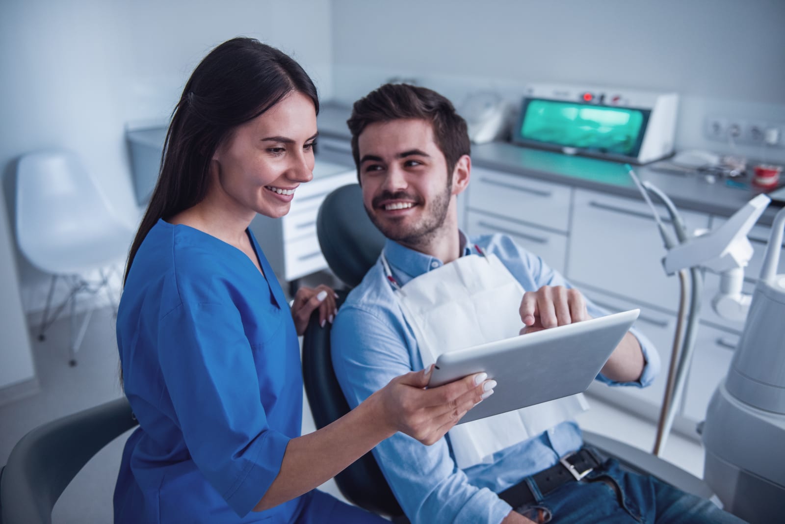 A hygienist goes over a treatment plan using visuals.